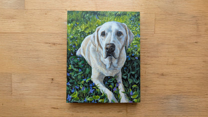 Canvas print of a white dog in a grassy field on a wooden surface